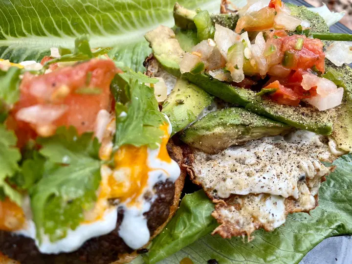 Mexican Burgers with fried egg, cilantro, pico de gallo, lettuce, and avocado